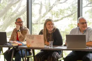 Students sitting with laptops